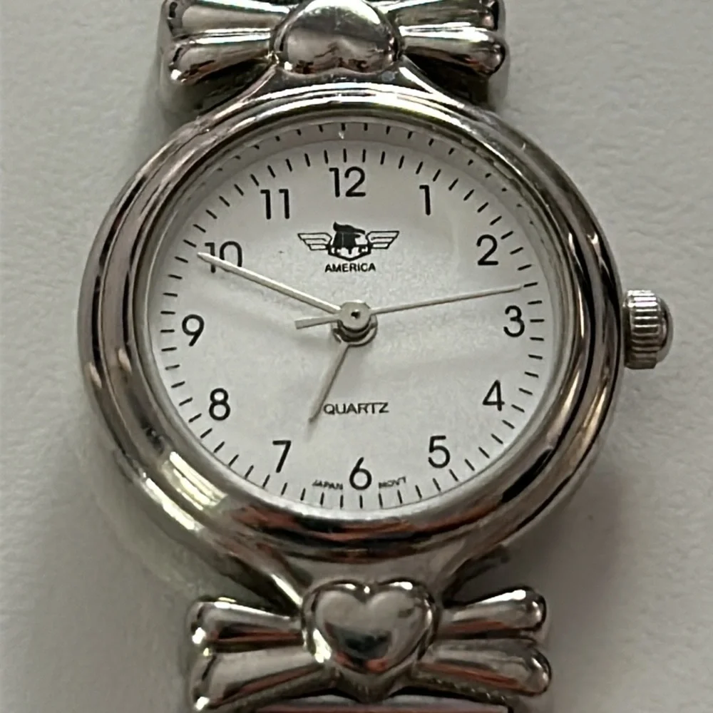 Two vintage quartz watches one stainless steel with hearts one with blue trim
